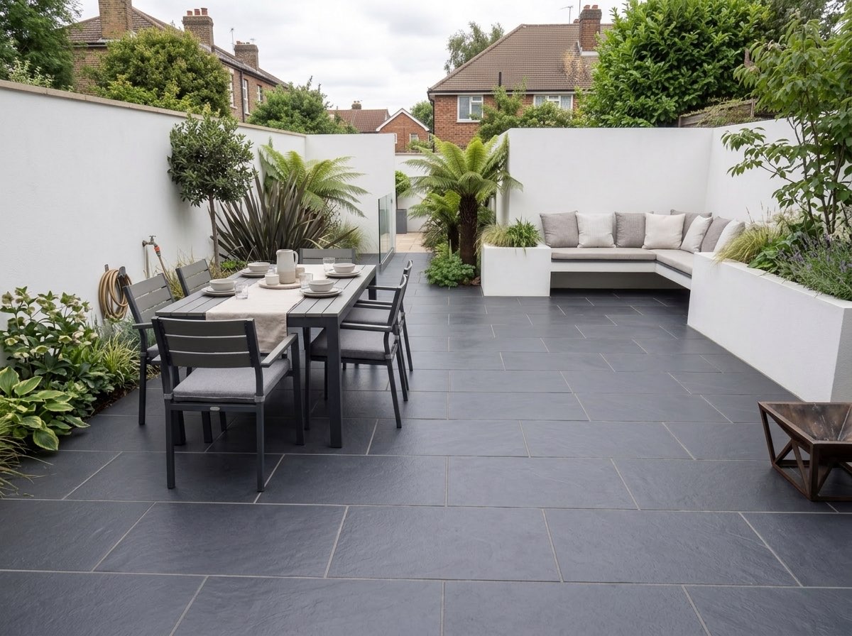 Grey outdoor porcelain paving laid around a garden dining area