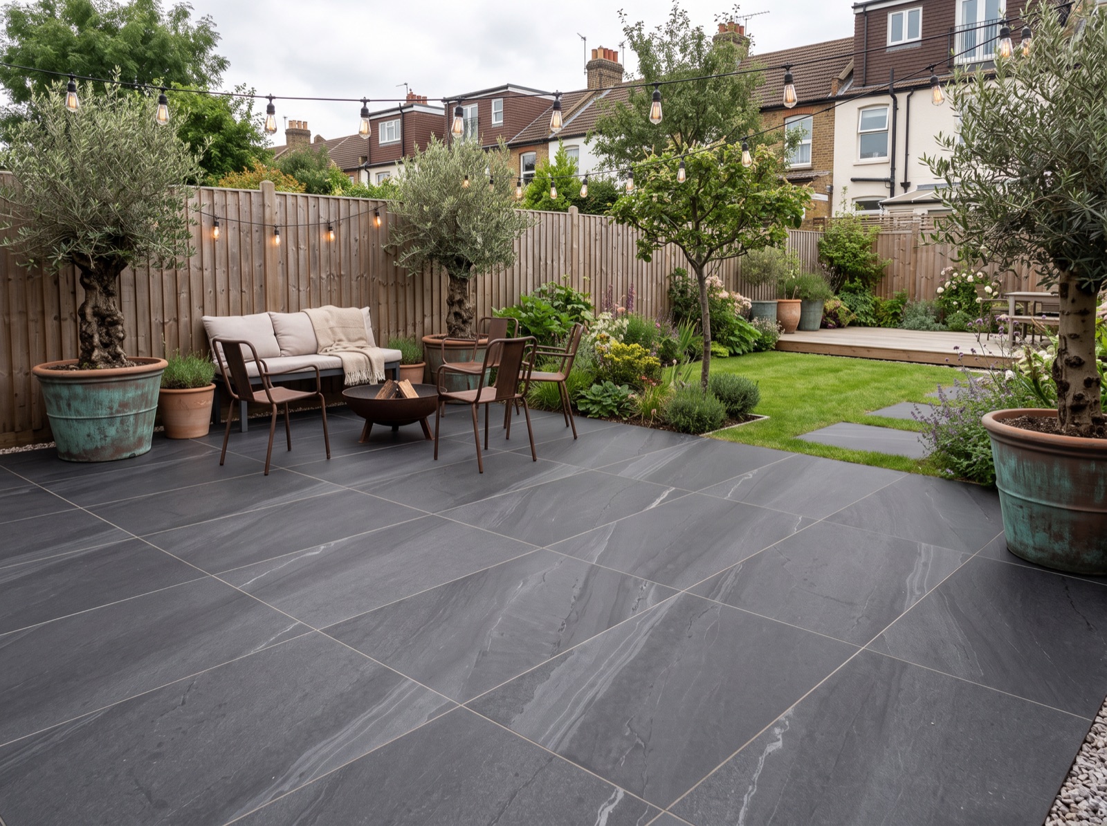 Dunestone Black Patio Porcelain Paving Slabs – 900×600 shown laid in a garden setting