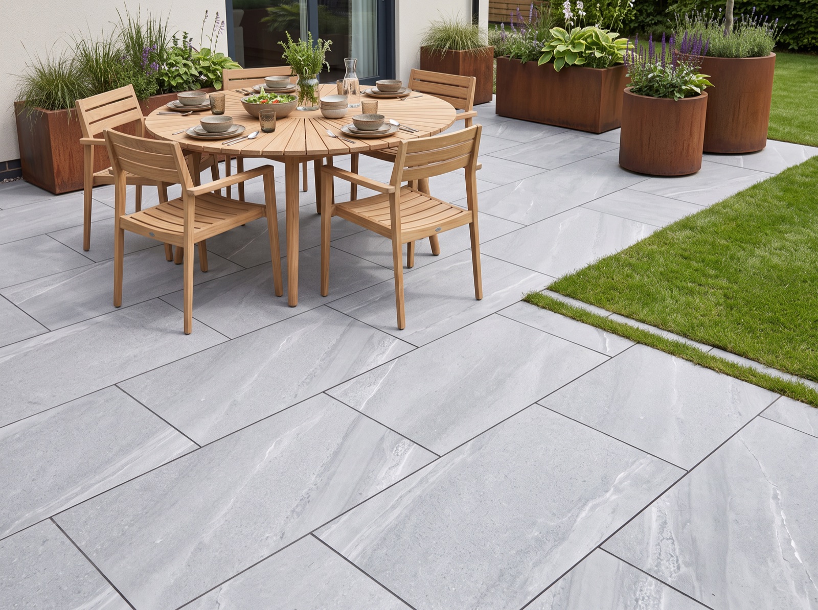 Dunestone Grey Outdoor Porcelain Patio Paving Slabs – 900×600 shown laid in a garden setting