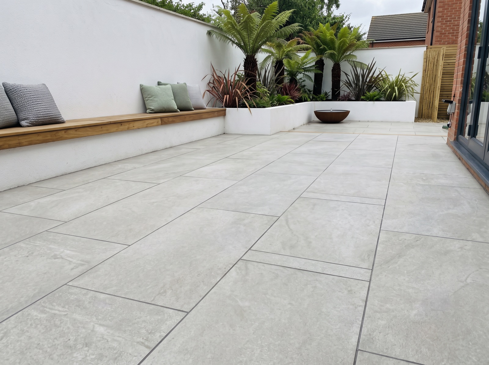 Hammer Stone Grey Outdoor Porcelain Paving Slabs – 900×600 – 20mm shown laid in a garden setting