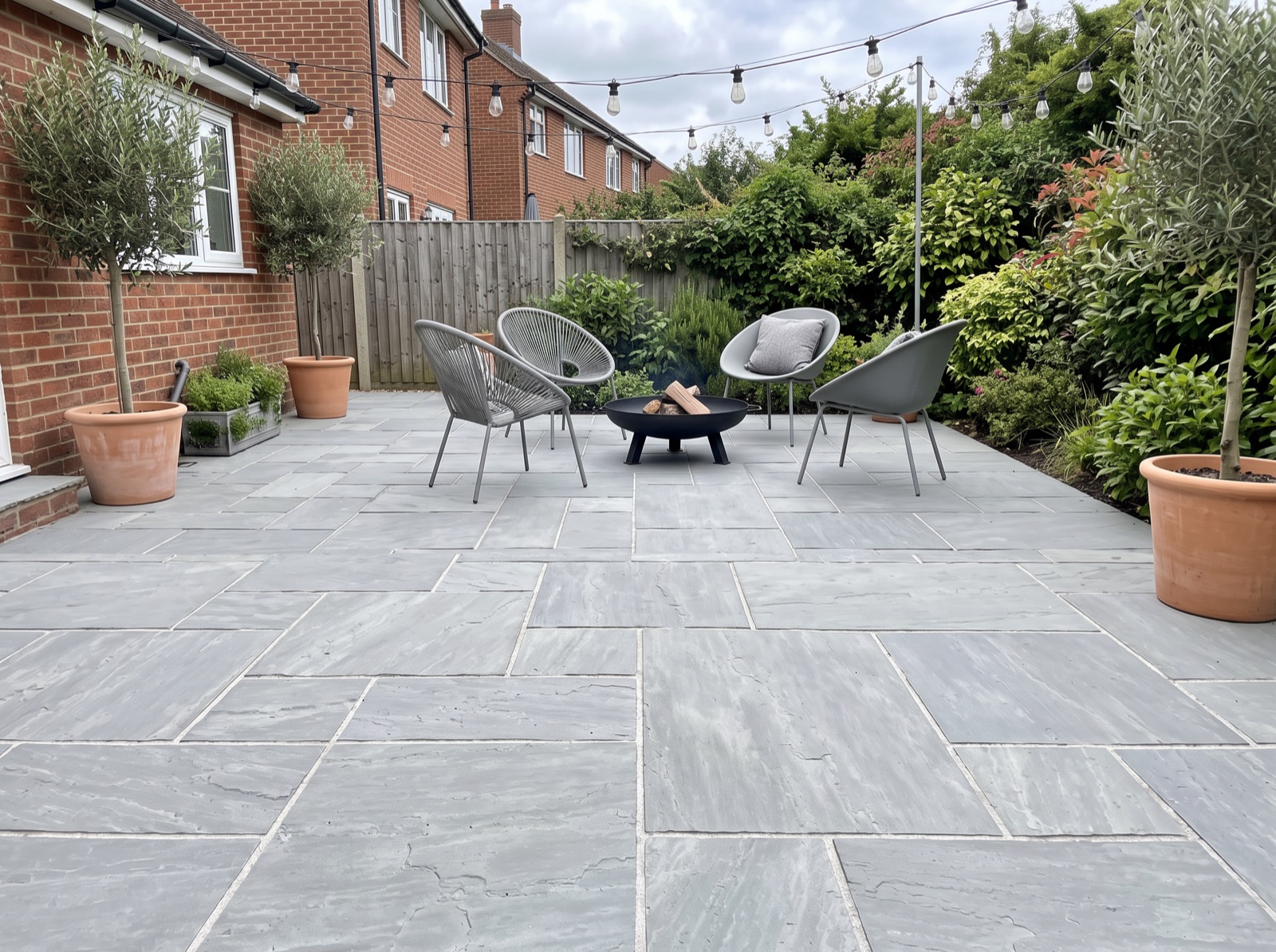 Natural Finish Sandstone Paving Slabs - Kandla Grey shown laid in a garden setting
