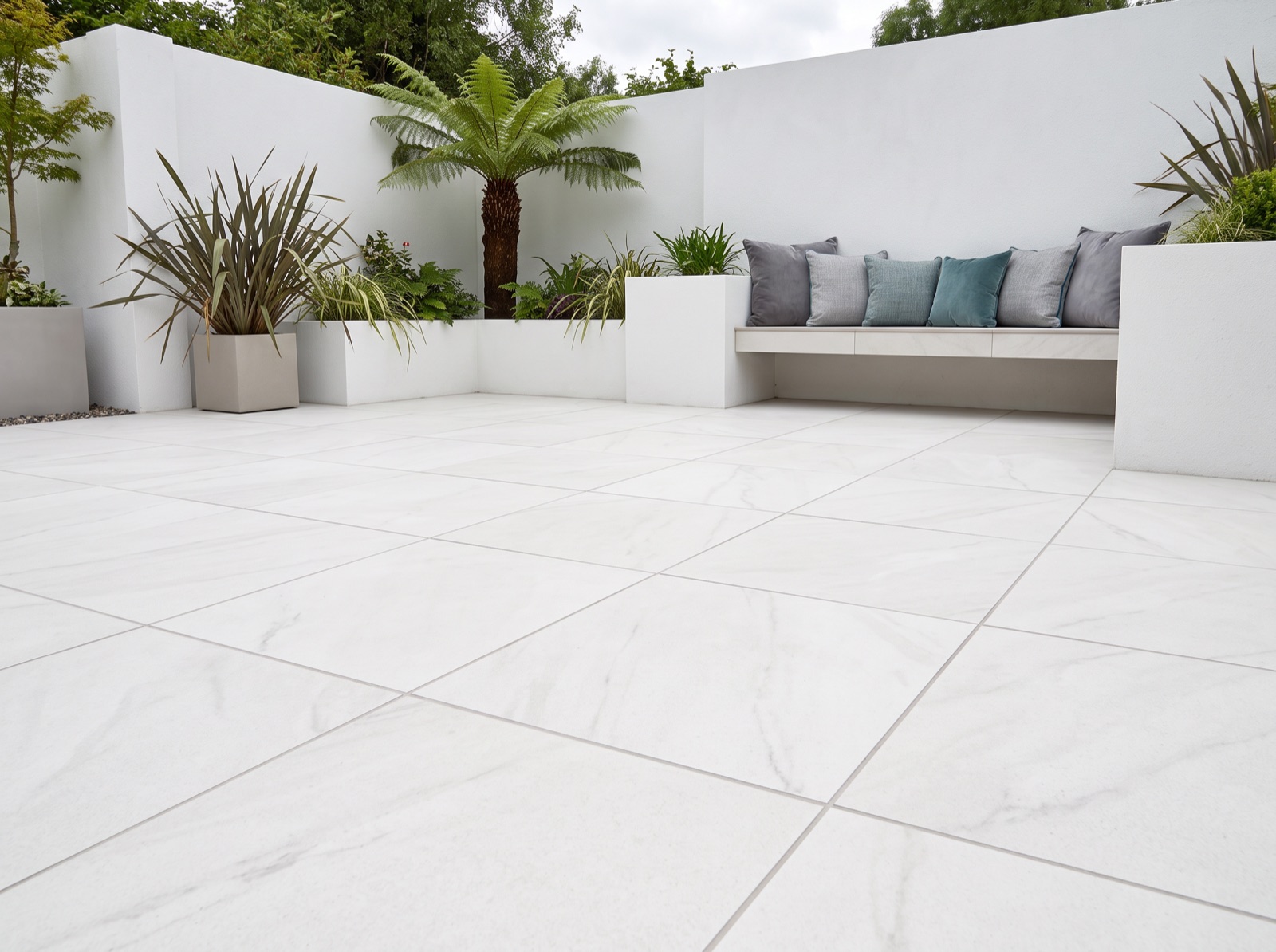Opal White Patio Porcelain Paving Slabs – 900×600 shown laid in a garden setting