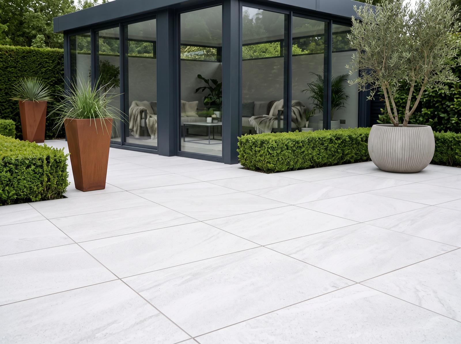 Prado White Patio Porcelain Paving Slabs – 900×600 – 20mm shown laid in a garden setting